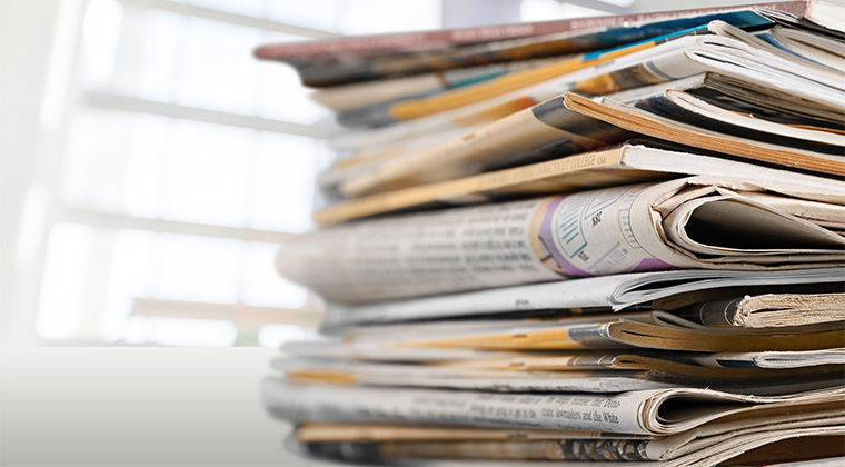 Stack of newspapers with Benefactor in the news