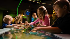 Fundraising stories represented by children at COSI.