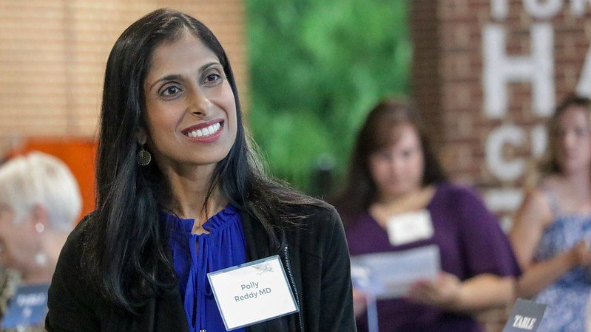 Columbus Medical Association Foundation conference goer smiles at presentation.
