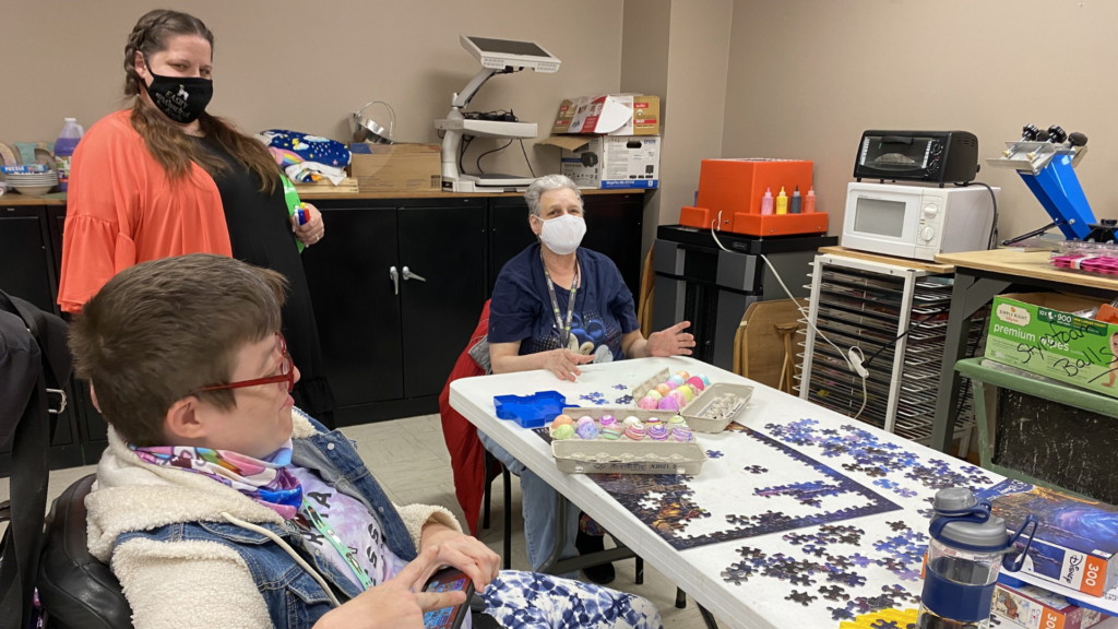 Easterseals Central and Southeast Ohio. Image shows three people doing a puzzle together.