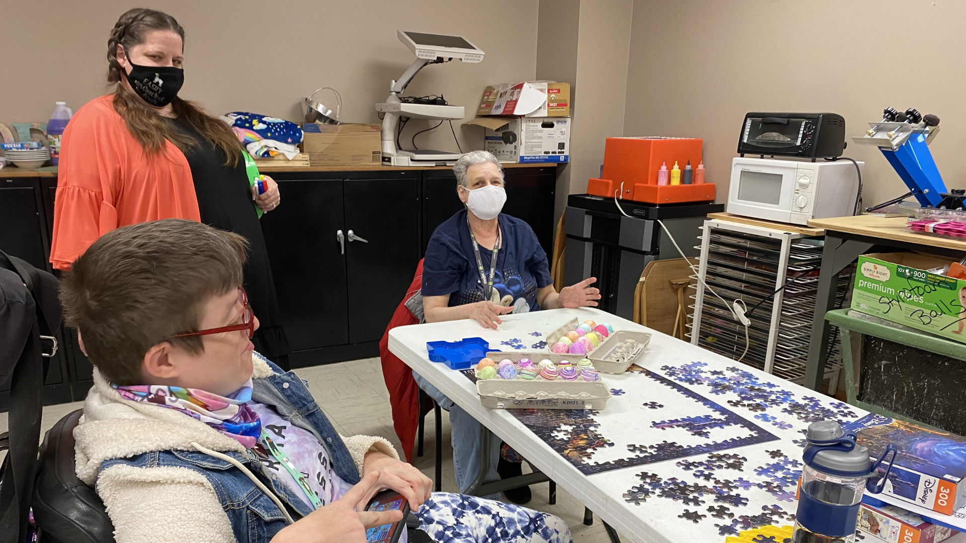 Easterseals Central and Southeast Ohio. Image shows three people doing a puzzle together.