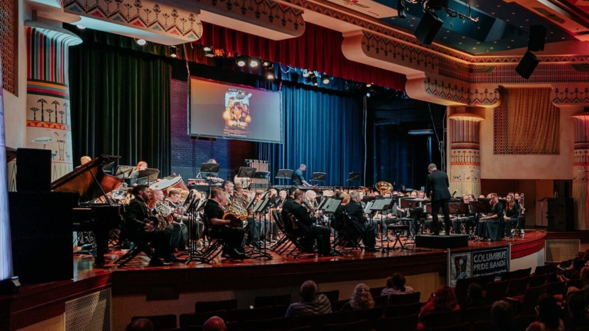 Greater Columbus Art Council. Image shows a musical performance in an ornate theater.