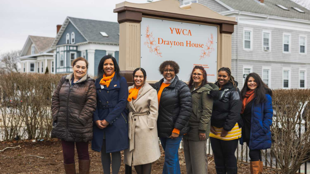YWCA of Southeastern Massachusetts. Women smiling in front of sign that says YWCA Drayton House.
