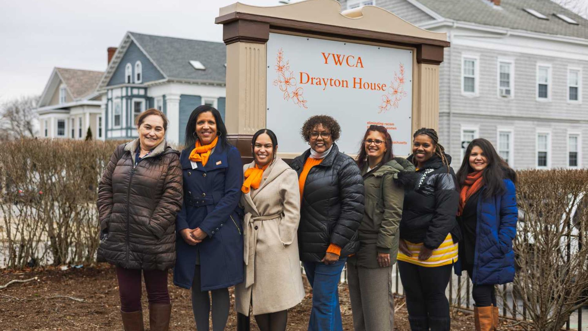 YWCA of Southeastern Massachusetts. Women smiling in front of sign that says YWCA Drayton House.