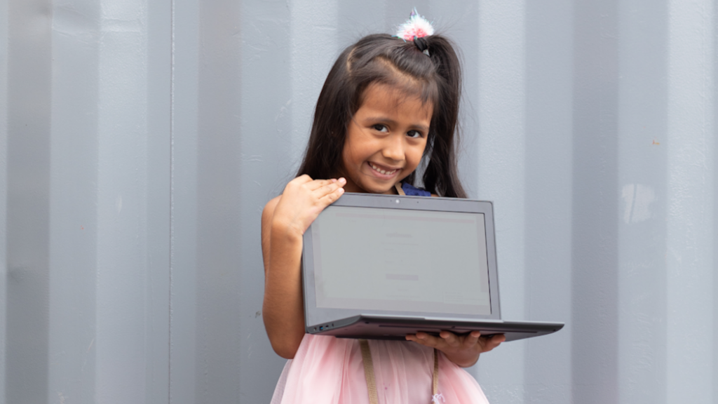 National Digital Inclusion Alliance. Image shows girl holding a laptop.