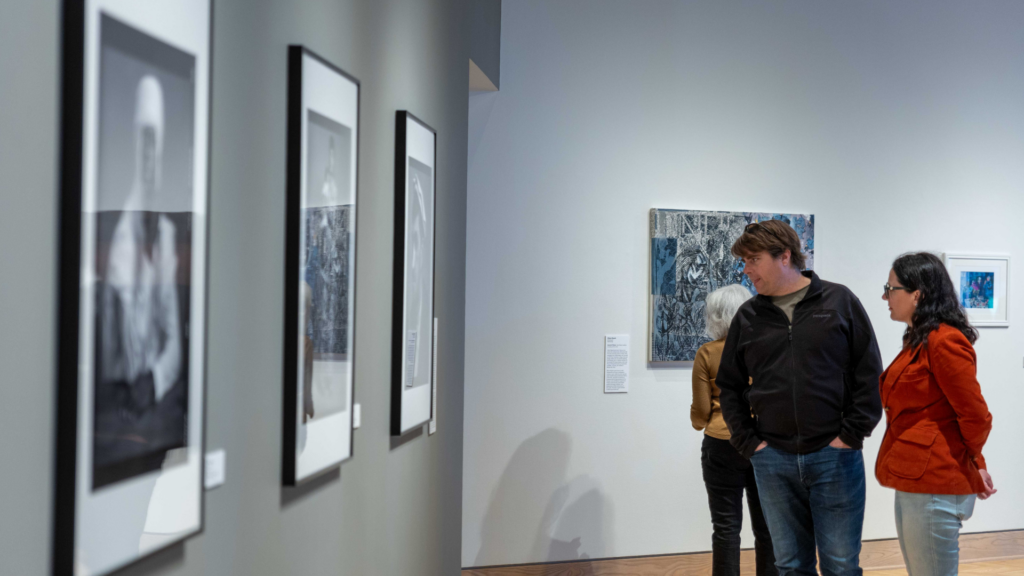 Ohio Arts Council. Image shows people looking at art.