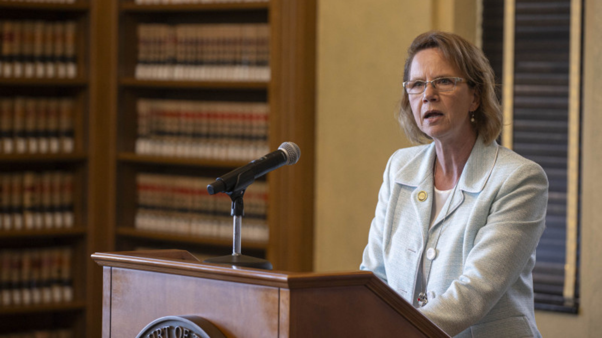 Ohio State Bar Foundation. Image shows woman speaking at a podium.