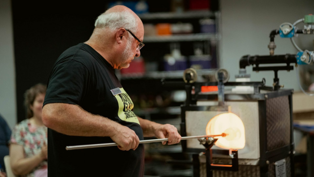 Bergstrom-Mahler Museum of Glass. Image shows a man glass blowing.