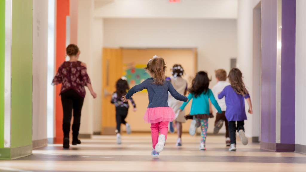 St. Vincent Family Services. Image shows children running down the hallway.