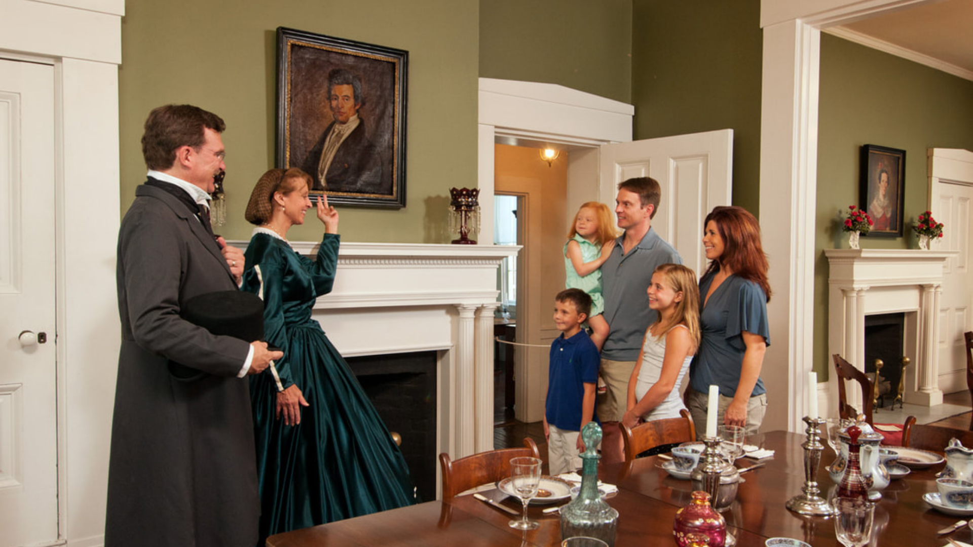 Warren County Historical Society. Image shows historical actors talking with a family.