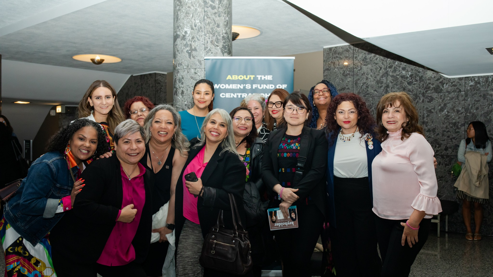 Women’s Fund of Central Ohio. Image shows group of women smiling at an event.