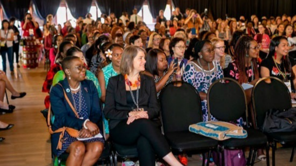 World YWCA. Image shows a large audience of mostly women.