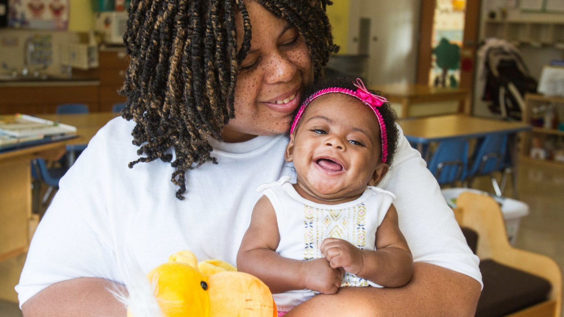 YWCA Columbus. Image shows a mother and her baby smiling.