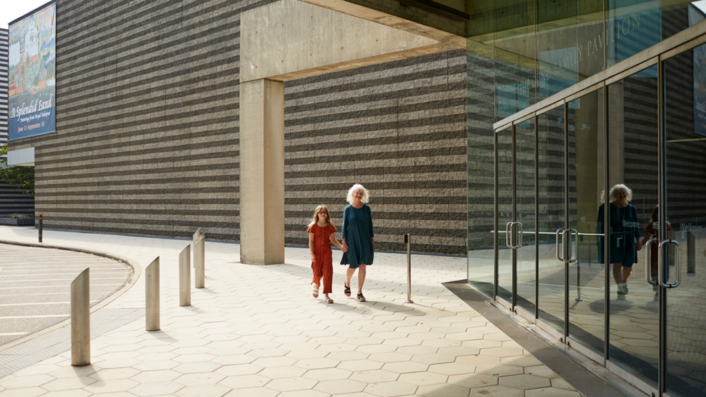 Cleveland Museum of Art. Image shows a grandmother and granddaughter walking outside of the museum.