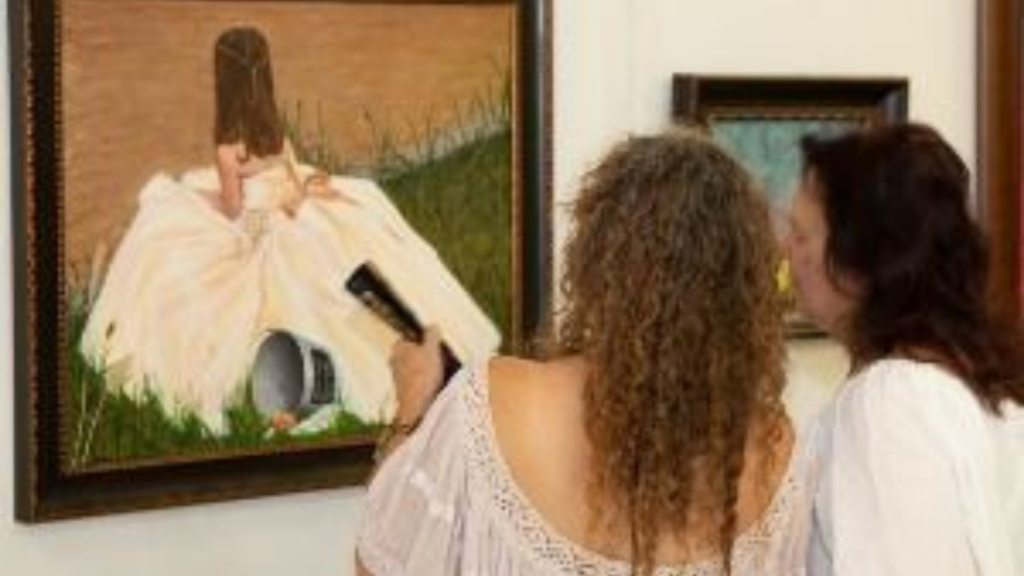 Colorado State Fair. Image shows two women looking at a painting.