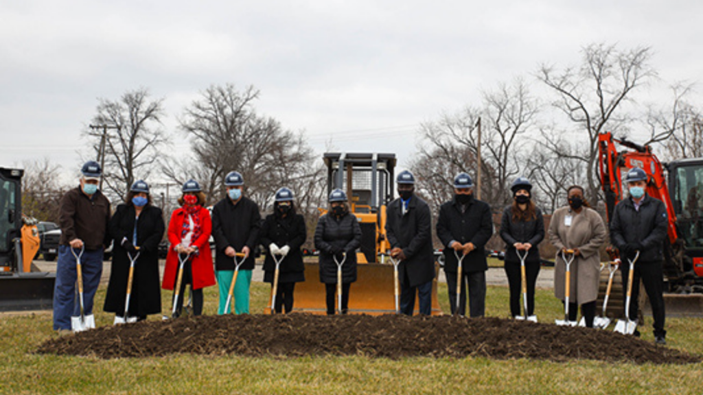 Finance Fund. Image shows group of people conducting a groundbreaking ceremony.