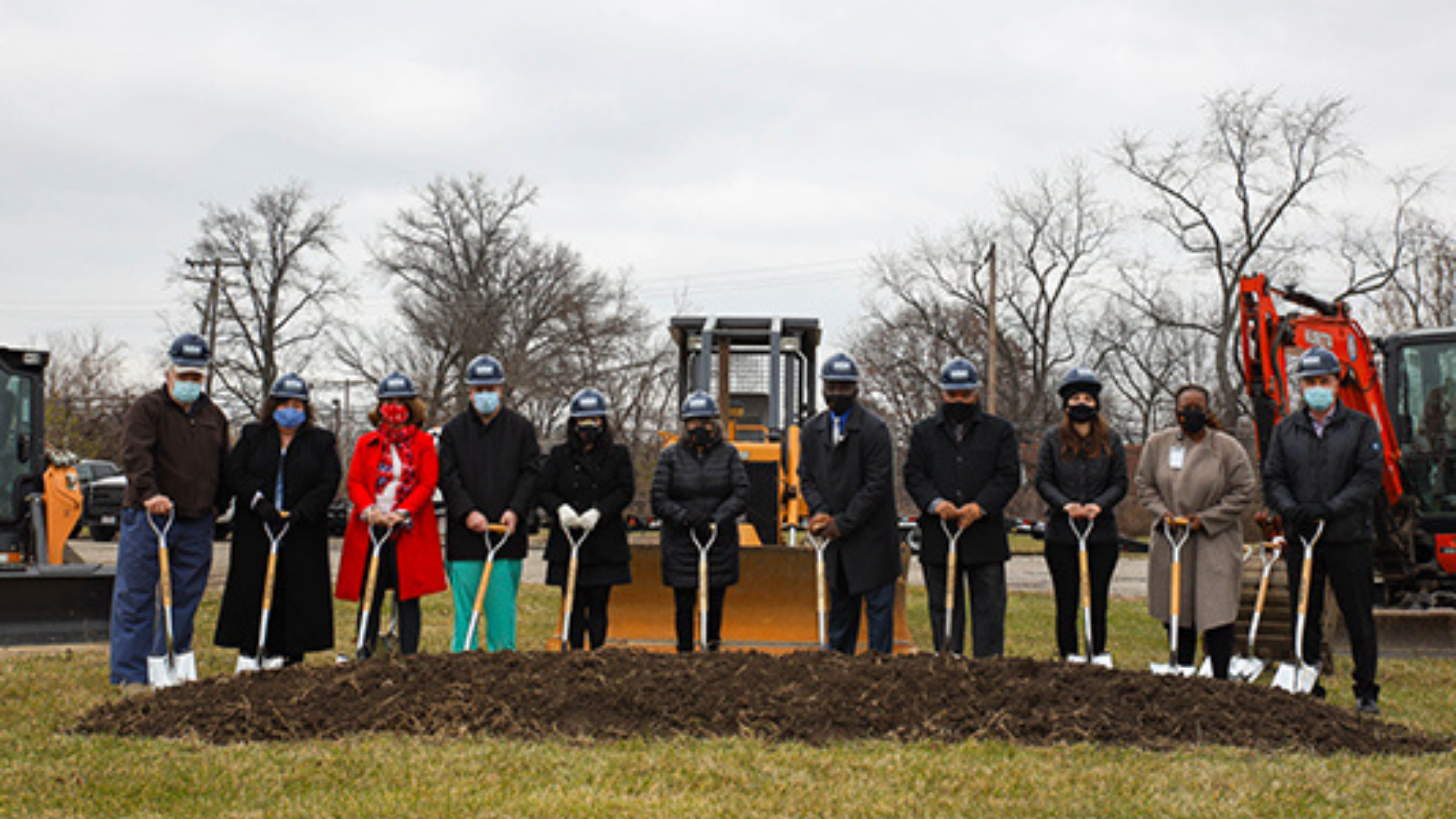 Finance Fund. Image shows group of people conducting a groundbreaking ceremony.