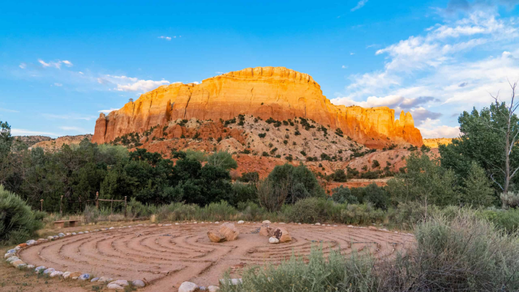 Ghost Ranch Education and Retreat Center. Image shows a meeting circle in front of a beautiful desert mountainscape.