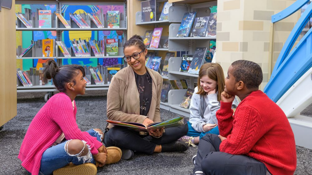 Greater Cincinnati Foundation and United Way of Greater Cincinnati. Image shows woman reading a book to children.
