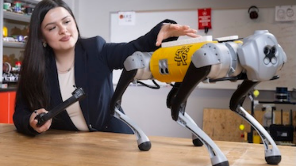 Kennesaw State University. Image shows a student working on a robot.