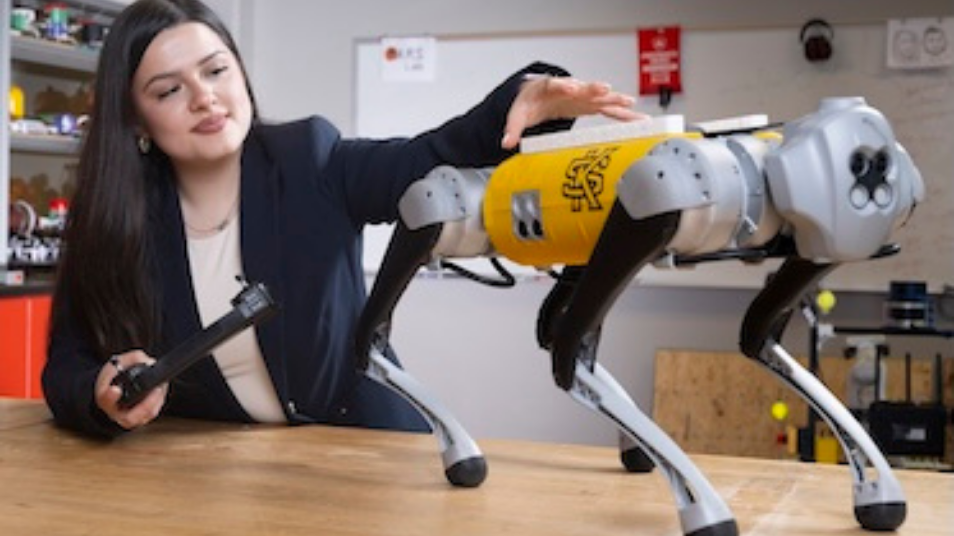 Kennesaw State University. Image shows a student working on a robot.