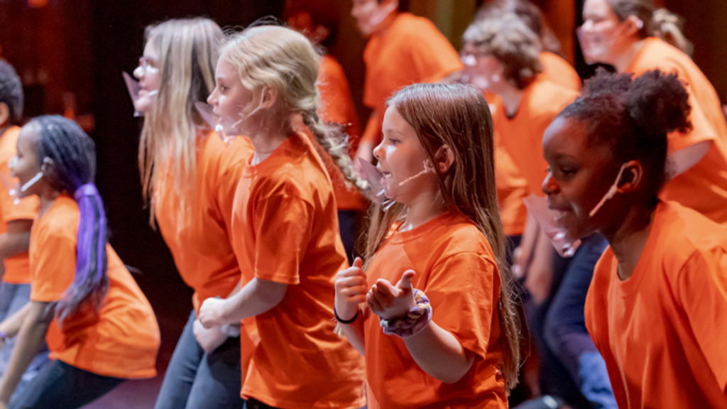 ArtsWave. Image shows children dancing and wearing matching shirts.