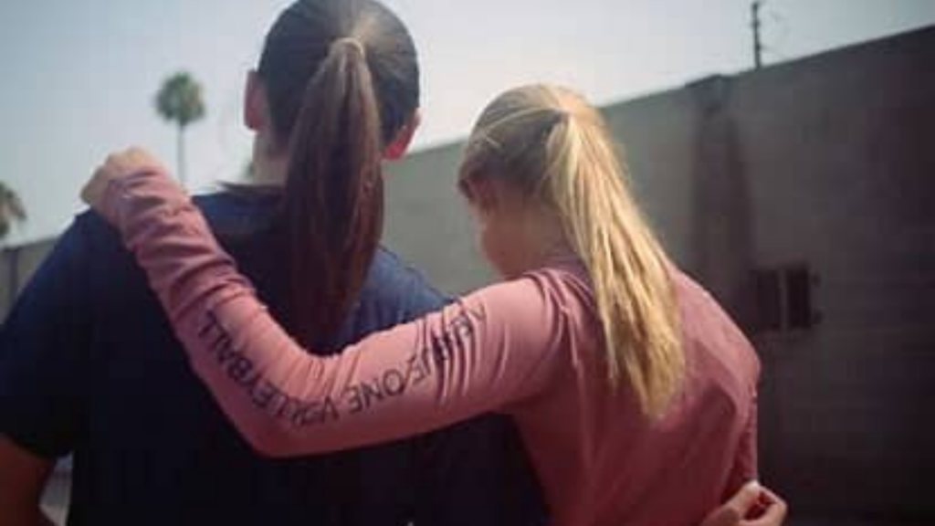 League One Volleyball Foundation. Image shows two players with their arms around each other.