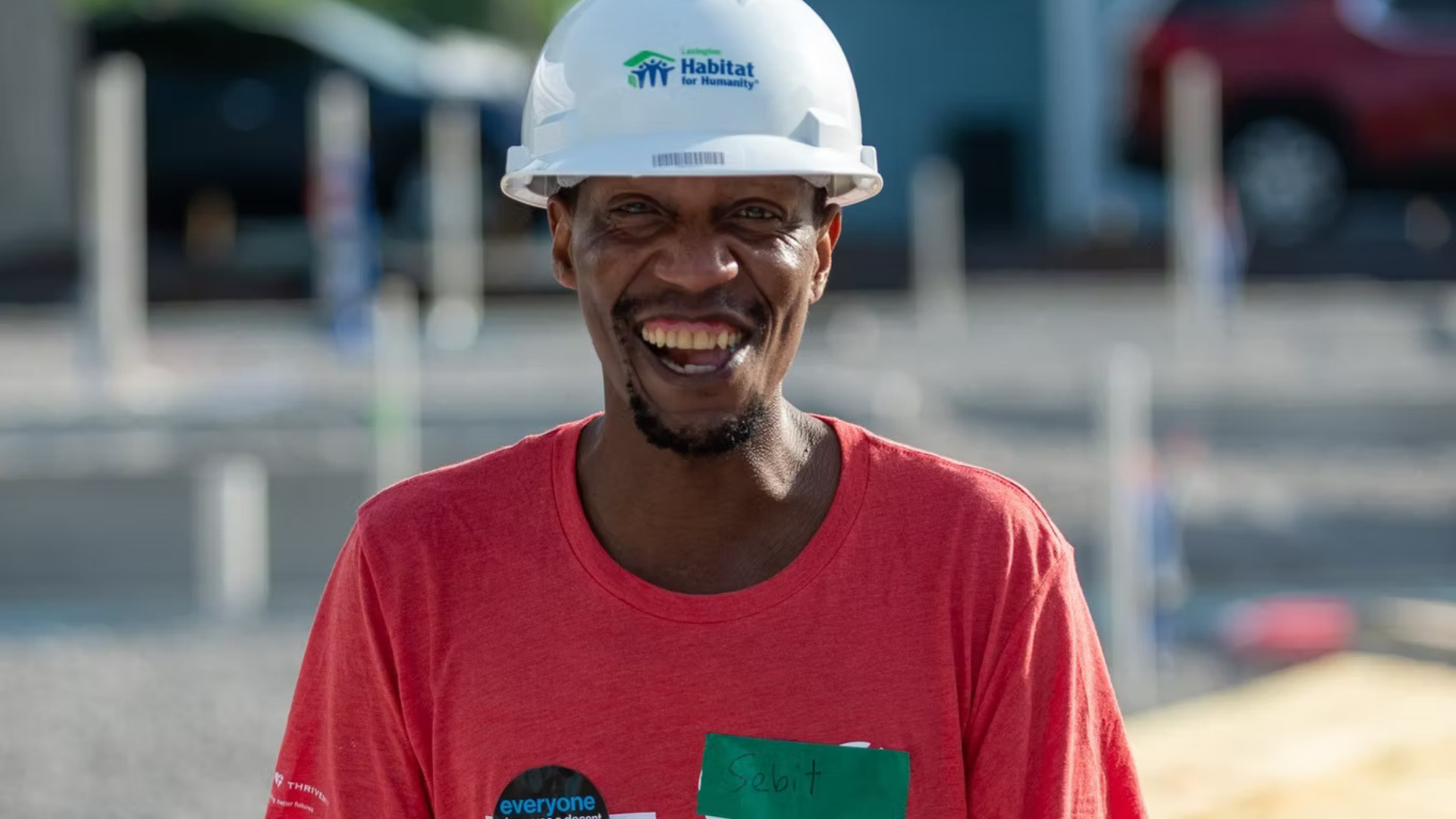 Lexington Habitat for Humanity. Image shows a man wearing a Habitat for Humanity hard hat and smiling.