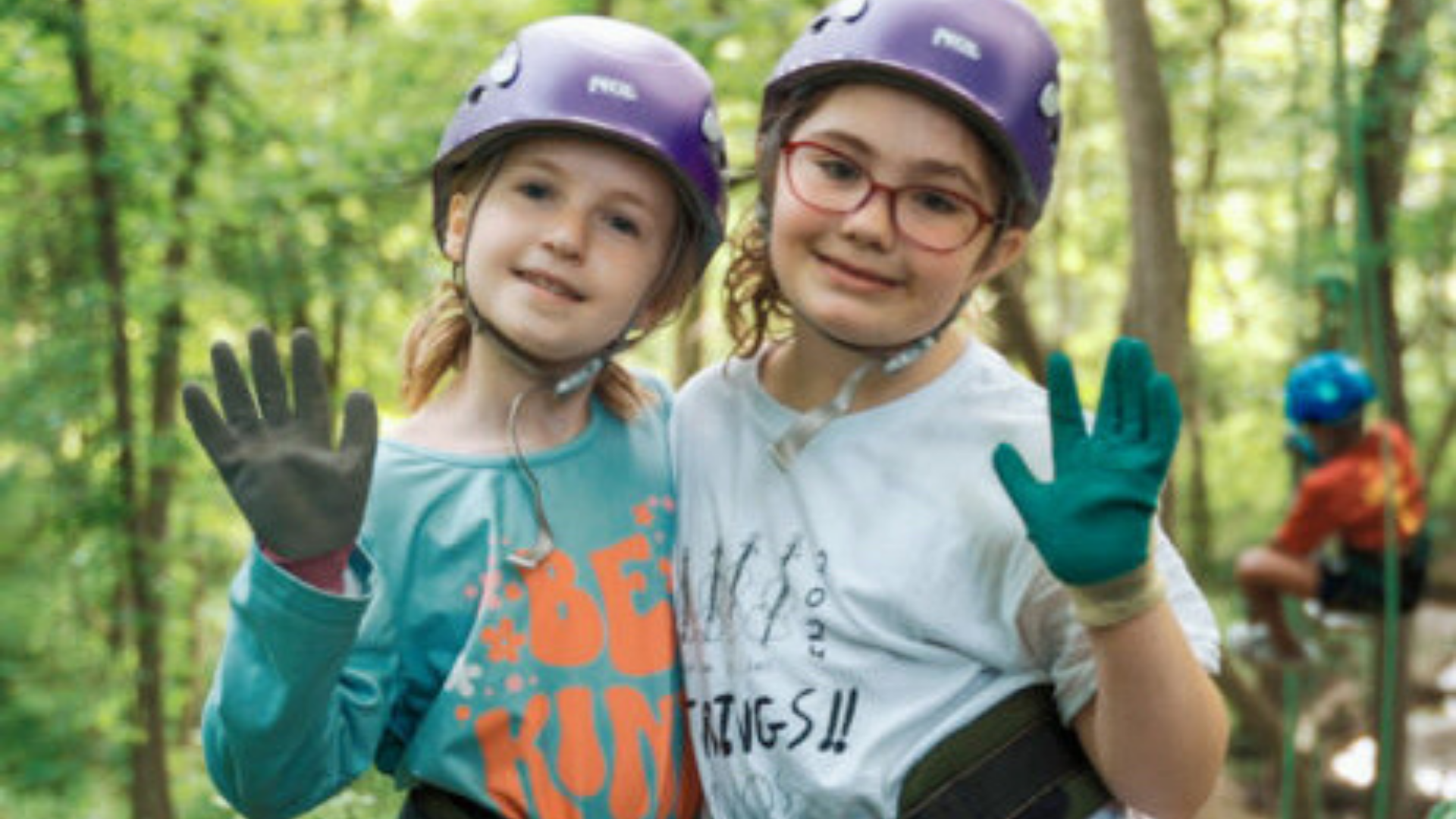 Maumee Valley Country Day School. Image shows two girls smiling before they do an outdoor adventure. They're wearing what looks like climbing gear.