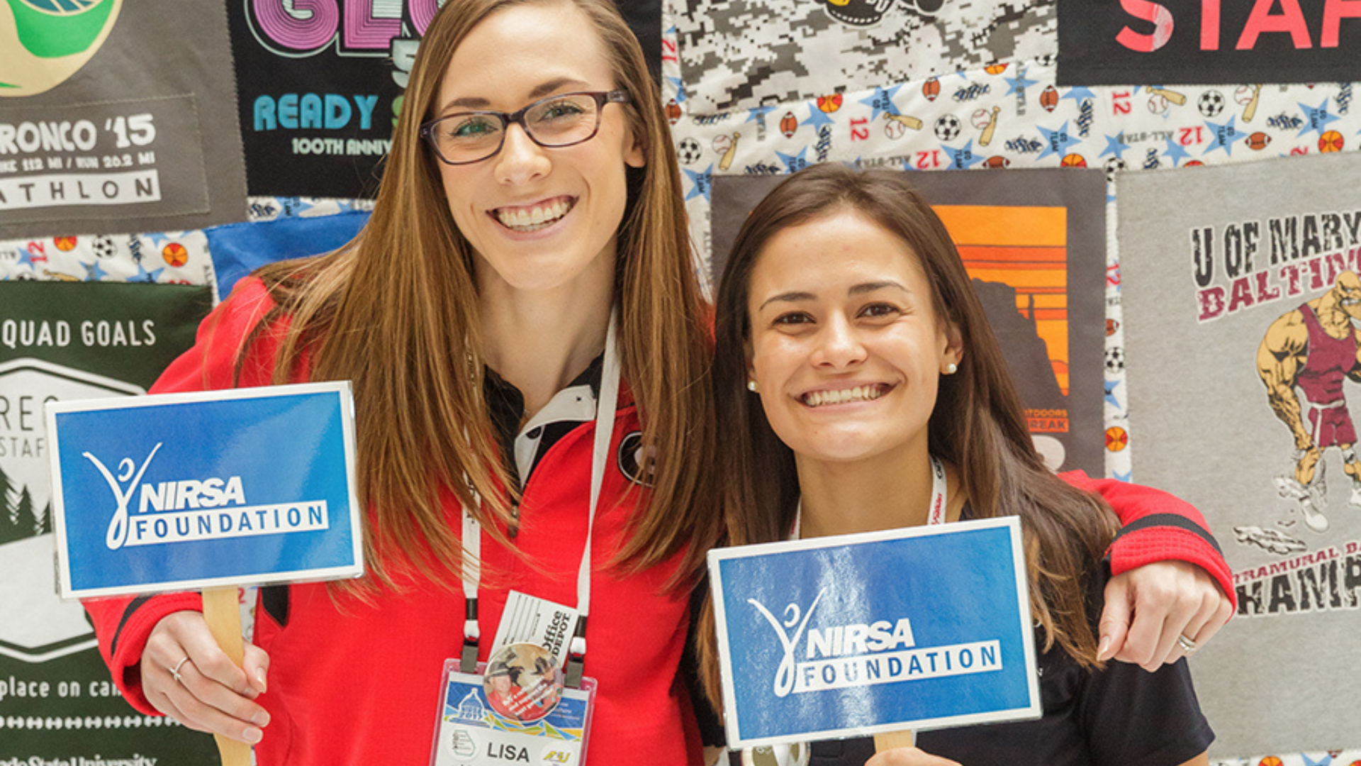 NIRSA Foundation. Image shows two women smiling holding NIRSA Foundation signs.