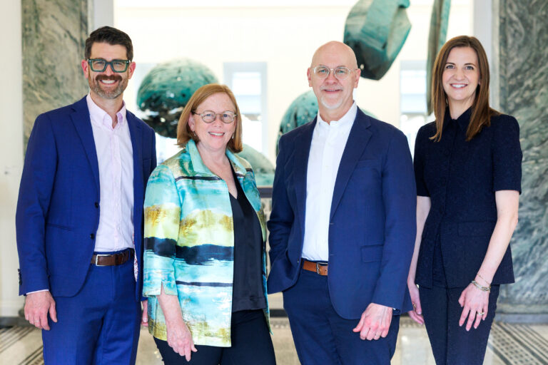 Benefactor Group Elevates Abby Shue and Adam Fazio to Partners, Advancing Its Next Chapter. Photo shows the four partners smiling together.